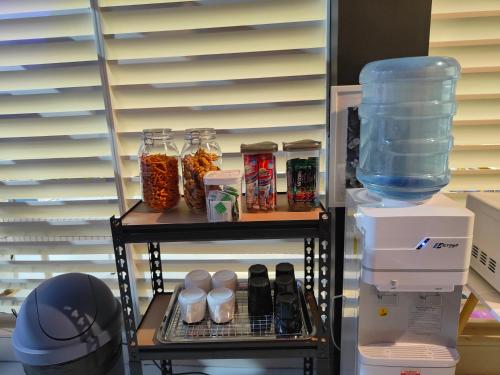 a shelf in a refrigerator with jars of food at Met A Space Pod @Phrom Phong in Bangkok