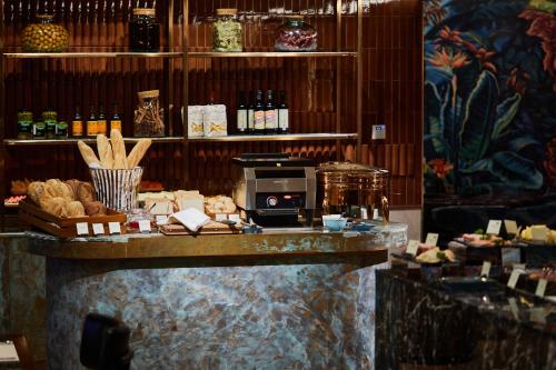 a counter in a store with bread and other items at Valia Hotel Bangkok in Bangkok