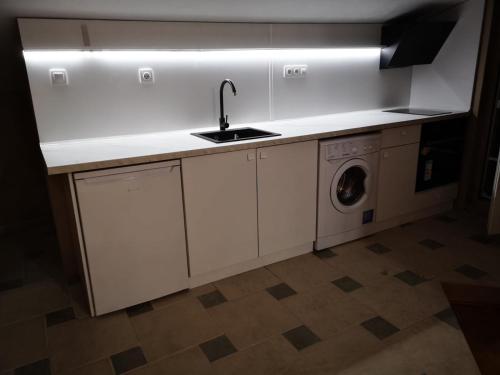 uma cozinha com um lavatório e uma máquina de lavar roupa em Black Sea Pearl em Černomorec
