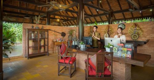 two women standing behind a counter in a room at Pandora Suite D'Angkor in Siem Reap