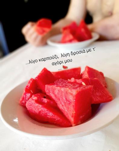 a plate of red watermelon on a table at Ble Mavi - Studio for 2 in Vouni