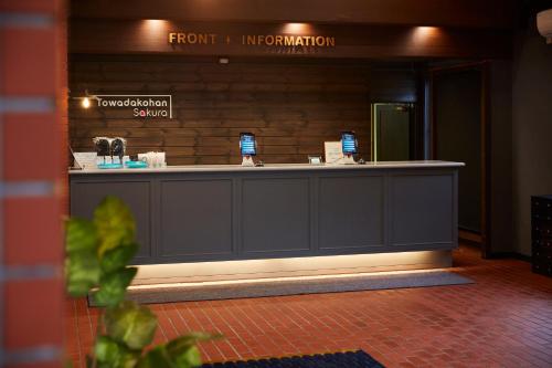 a reception counter in a building with a sign at Towadakohan Sakura in Towada