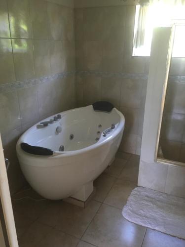 a white bath tub in a bathroom with a window at Retreat Guest House in Falmouth