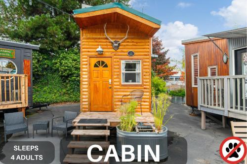 a small cabin with a wooden door on a patio at Tiny Digs - Hotel of Tiny Houses in Portland