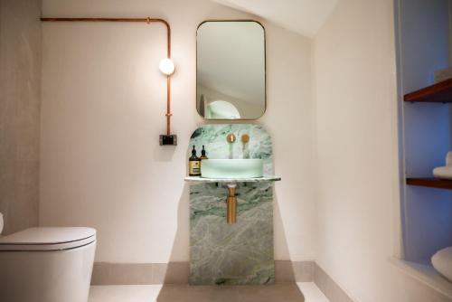 uma casa de banho com um lavatório e um espelho em Warders Hotel Fremantle Markets em Fremantle