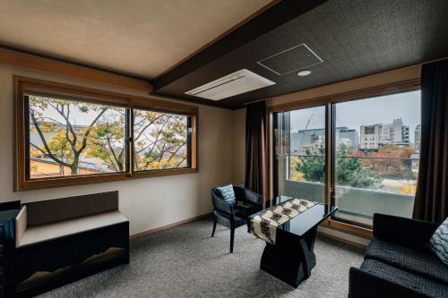 a living room with a couch and a window at Hotel Alza Kyoto in Kyoto