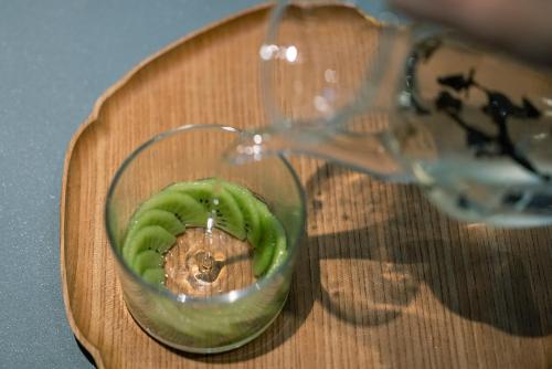 a wine glass with a green pepper on a cutting board at moksa in Kyoto