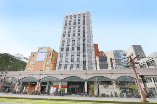 a tall building on a street in a city at QuintessaHotel KagoshimaTenmonkan Relax&Sleep in Kagoshima