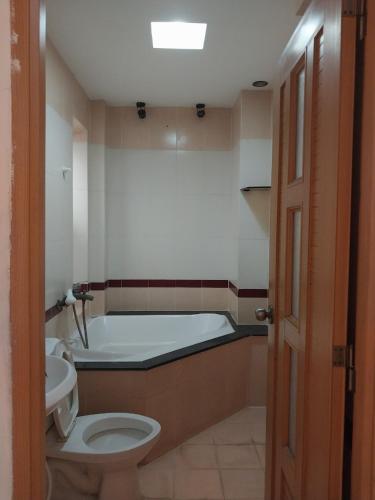 a bathroom with a bath tub and a toilet at Khách sạn Mai Hoàng 2 in Ho Chi Minh City
