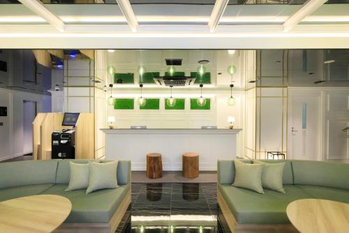 a living room with a couch and a bar at QuintessaHotel KagoshimaTenmonkan Relax&Sleep in Kagoshima