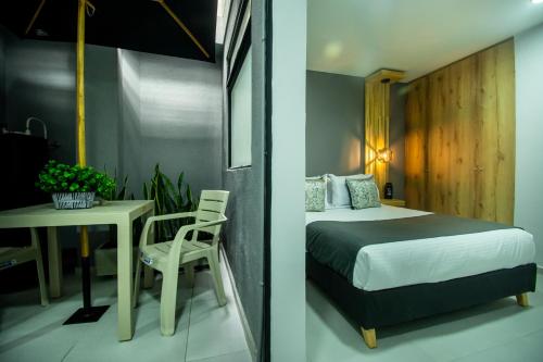 a bedroom with a bed and a table with a chair at Barcelo Coliving in Medellín