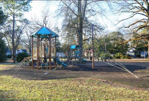 a playground in a park with a swing set at Short Walk to JSU Stadium, Hospitals, and Bars in Fondren in Jackson
