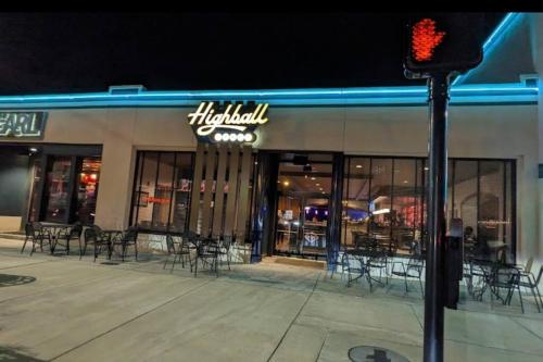 a restaurant with tables and chairs outside at night at Short Walk to JSU Stadium, Hospitals, and Bars in Fondren in Jackson