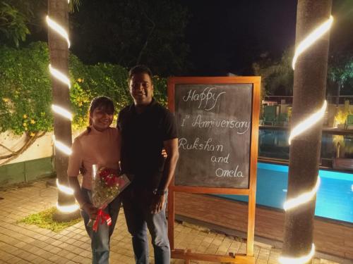 a man and a woman standing in front of a sign at Morning Star Resorts in Negombo