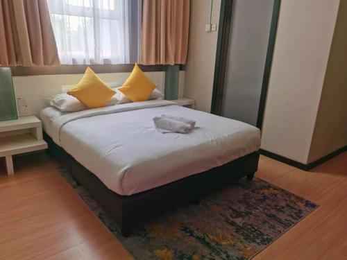 a bedroom with a bed with a stuffed animal on it at Lovita Hotel Kuantan in Kuantan