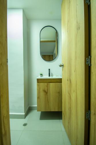 a bathroom with a wooden sink and a mirror at Barcelo Coliving in Medellín