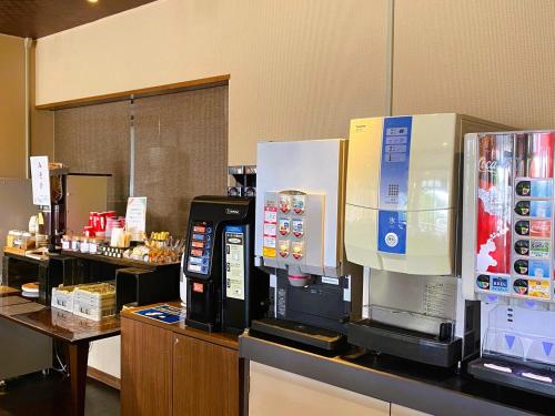 a coffee shop with a coffee machine on a counter at Iioka Shiosai Hotel in Asahi