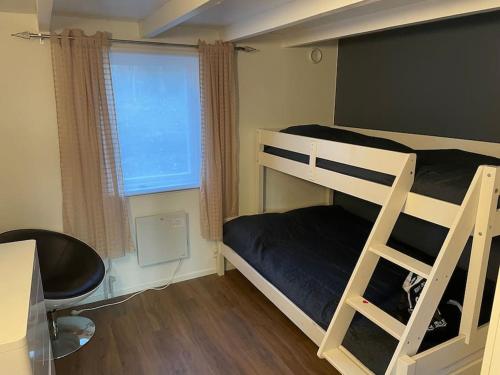 a bedroom with two bunk beds and a window at Nyrenoverat strandnära med fantastisk utsikt in Rimbo
