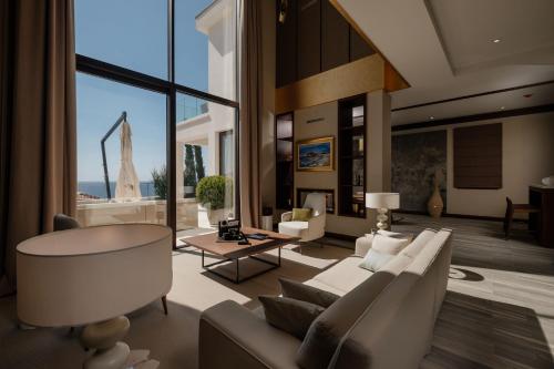 a living room with a couch and a table at Signature Villa in Budva