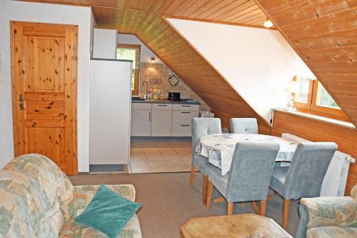 a kitchen and dining room with a table and chairs at Jasmunder Ferienwohnung in Sagard
