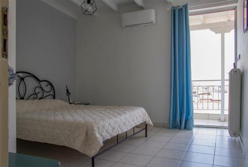 ein Schlafzimmer mit einem Bett und einem großen Fenster in der Unterkunft Beautiful Loft Ilion in Athen