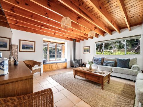 a living room with a couch and a table at Beachfront Bliss, waterfront Geographe bay in Busselton