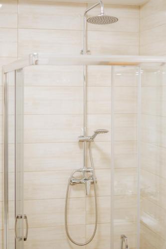 a shower with a glass door in a bathroom at Elina Apartman in Keszthely