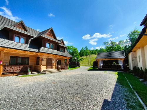 a house with a driveway next to a building at U Dziadka in Chochołów