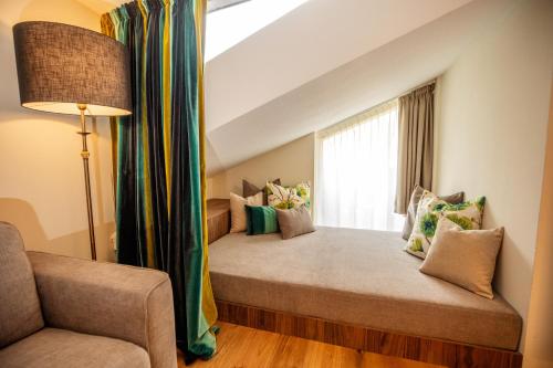 a room with two beds with a window at Moseralm Dolomiti Spa Resort in Nova Levante