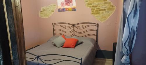a small bed with two pillows on it in a room at Casa Vacanza Dany House in Dogliani