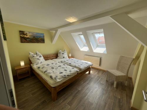 a bedroom with a bed and two skylights at Altstadtapartment in Neuhaldensleben