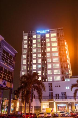 a large building with a sign on top of it at The Signature Serviced Suites Puchong in Puchong