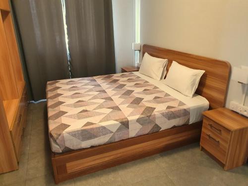 a bedroom with a bed with a checkered comforter at Malvilla in Pereybere