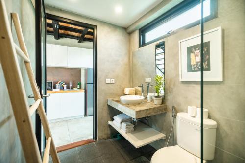 a bathroom with a toilet and a sink at Canggu 2Plex Apartment in Canggu