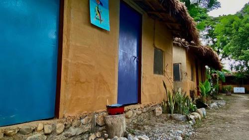 a building with a blue door on the side of it at River Park Retreat in Sauraha