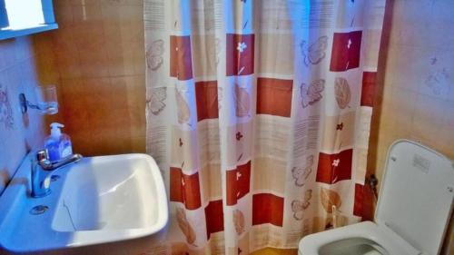 a bathroom with a sink and a shower curtain at Rose Garden 2 in Kavos
