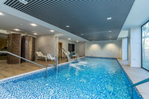 a large swimming pool in a room with a ceiling at Oasis 325 New Luxury Penthouse with amazing sea view and private jacuzzi in Estepona