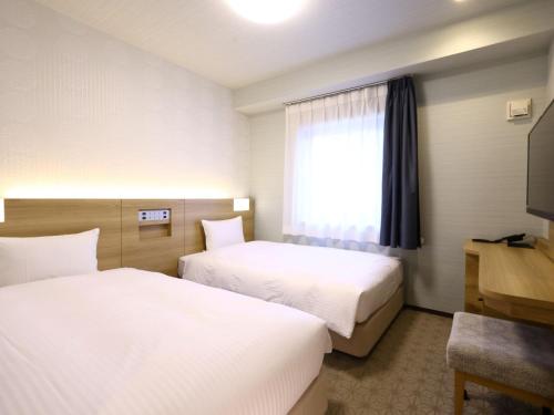 Postel nebo postele na pokoji v ubytování ホテル B Suites なんば黒門