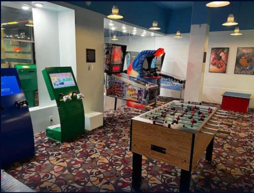 a room with a video game room with a foosball table and a video at Clayton Plaza Hotel & Extended Stay in Clayton