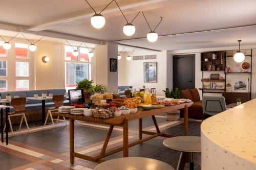 a living room with a table with food on it at Best Western Plus Hotel Cargo in Dunkerque