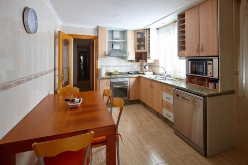 a kitchen with a wooden table and a counter top at ECO-MANOLITA in Elche