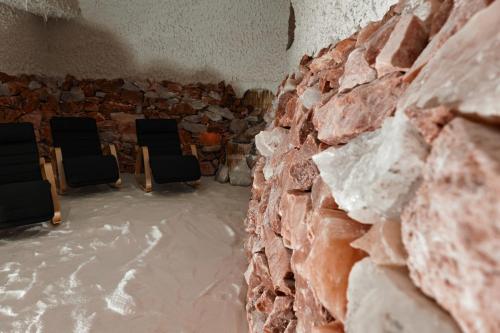 two chairs in a room with a brick wall at Hotel Aurora in Tivoli Terme
