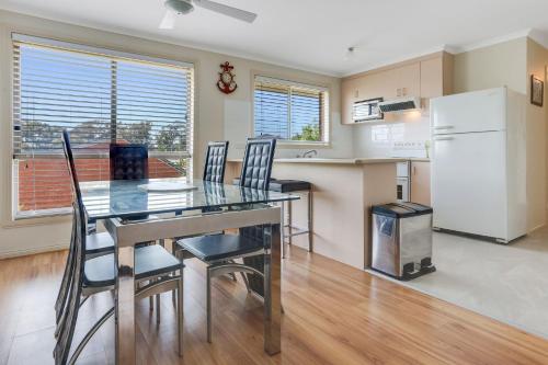 a kitchen and dining room with a table and chairs at Hidden Gem Bermagui fishing friendly pet friendly Bermagui in Bermagui
