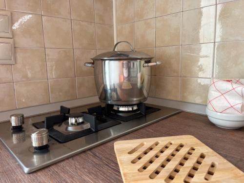 a pot on top of a stove in a kitchen at Pettas Apartments in Zakynthos Town