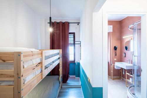 a room with a bunk bed and a bathroom at MyTinyHome Festina Lente in Rome