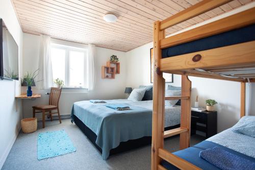 a bedroom with a bed and a bunk bed at Stone Mountain BnB in Stenbjerg