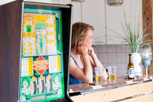 a woman sitting at a bar looking at a computer screen at Stone Mountain BnB in Stenbjerg