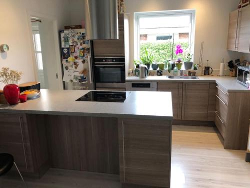 a kitchen with a large island in the middle at House close to the city in Copenhagen