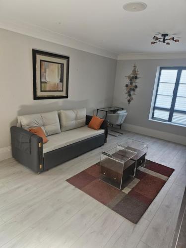 a living room with a couch and a coffee table at Luxury Room in Harold Wood