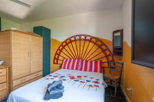 a bedroom with a bed with a large wooden headboard at Villa Olivia pool tennis spa - C in Lecce